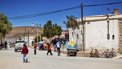 Bustling street scene with people attending a market or meeting in sunny surroundings, San Antonio