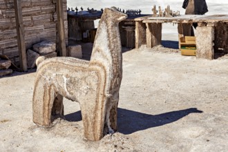 Salt sculpture of an alpaca in a rustic, bright desert environment, salt sculptures in the Salar de