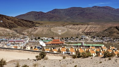 View of a small village in a hill and mountain landscape with central antenna, San Antonio de los