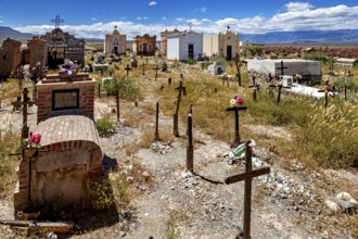 Old cemetery with graves and crosses under a blue sky with clouds, The cemetery of Cachi in