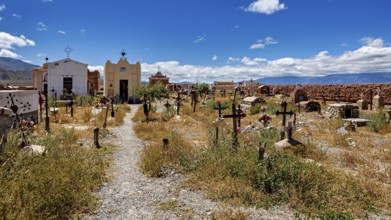 Path through an old cemetery with chapels and crosses in sunny weather, The cemetery of Cachi in