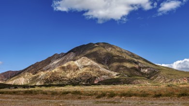 Volcanic landscape under a blue sky with scattered clouds, The landscape of the Quebrada with its