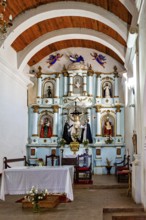 Richly decorated interior of a church with altar, figures and wooden ceiling, Iglesia San José de