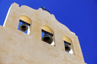Close-up of a yellow bell tower under bright blue sky, Iglesia San José de Cachi in Argentina
