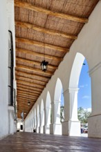 Colonial arcade with wooden roof, bright and open to the surrounding area, The arcades of Cachi in