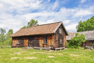 Old rustic wooden croft with weathered timber accompanied by a barn in a rural setting in a