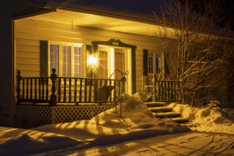 Entrance to a house lit by a lamp, Region of la Mauricie, Province of Quebec, Canada