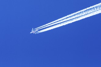 Emirates Boeing 777 flying high in the blue sky over Quebec. Province of Quebec, Canada