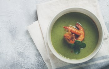 Pea cream soup, with shrimp, green soup, homemade, top view, no people
