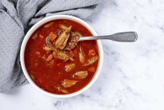 French shrimp bisque soup, on a marble table, close-up, no people