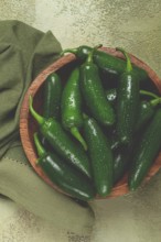 Fresh padron pepper, raw, in a wooden bowl, on the table, there are no people