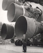 Dr. Wernher von Braun in front of the Saturn V engines around 1969, weapons technology, weapon