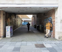 Graffiti sprayed walls in alleyway street in city centre of Plymouth, Devon, England, UK