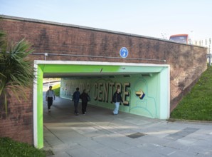 People walking through underpass subway at North Cross roundabout city centre of Plymouth, Devon,