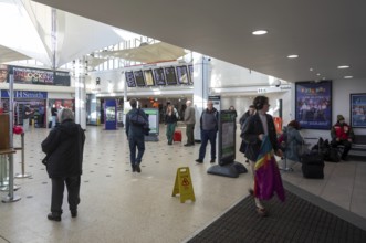 People in concourse of railway station at Plymouth, Devon, England, UK