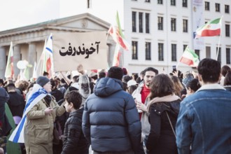 A person holds up a sign with the inscription The Mullah Went during the demonstration by exiled