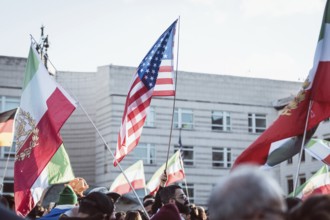 Flags of Iran and the USA during the demonstration by exiled Iranians under the slogan Freedom for