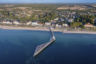 Aerial view over Seebrücke, pier and sandy beach at seaside resort Haffkrug along the Baltic Sea,