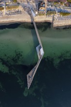 Aerial view over Seebrücke, pier and sandy beach at seaside resort Haffkrug along the Baltic Sea,