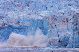 Ice chunk breaking from edge of calving Kongsbreen, marine-terminating glacier debouching into