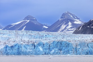Calving ice wall of Kongsbreen, marine-terminating glacier debouching into Kongsfjorden in summer,