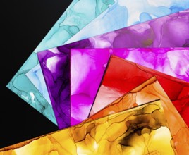 A collection of vibrant abstract ink backgrounds showcasing various vivid colors on paper. Perfect