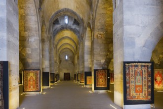 Stony vaulted interior with patterned carpets on display, Sultanhani caravanserai, on the former
