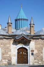 Turquoise dome on historic mausoleum nestled against a blue sky, Mevlana Museum, Mevlana, landmark,