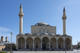 Historic mosque with two minarets and an impressive dome under clear skies, Selimiye Mosque, Konya