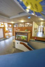 Colourful entrance area with aquarium and wooden decor, Schlehengäu Grund Schule Gechingen, Calw