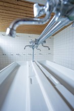 Close-up of a laundry room with silver faucets and white ceramic sinks, Schlehengäu Grund Schule