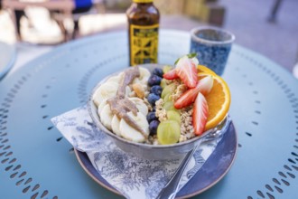 A delicious and healthy breakfast with fresh fruits such as strawberries and bananas on a café