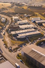 View of an industrial area with roads, buildings and surrounding fields on an afternoon, Calw, Calw