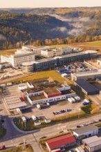 Industrial building on the edge of a forest with hills in the background, new hospital at the Calw