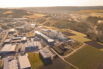 Extensive industrial area against a rural backdrop at golden hour, new hospital at Calw Health