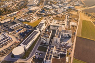 Aerial view of a modern industrial plant surrounded by city and nature, new hospital at the Calw