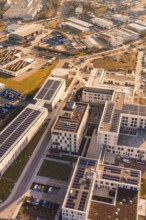 Urban aerial view with solar panels and industrial buildings, new hospital at Calw Health Campus,