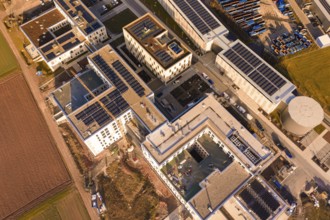 Bird's eye view of building roofs with solar panels and industrial structure, new hospital at Calw