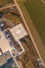 Aerial view of a helipad next to a path and agricultural fields, new hospital at Calw Health