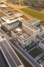 Modern architecture using solar energy in an urban facility surrounded by fields, new hospital at