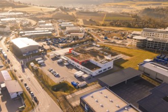 Industrial area with various warehouses and vehicles in an urban environment, new hospital at the