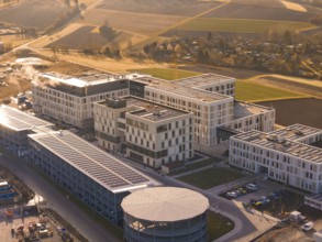 Modern buildings in a rural region with fields and autumn sounds in the evening light, new hospital