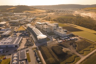 Industrial area and fields viewed from above in morning fog, new hospital at Calw Health Campus,