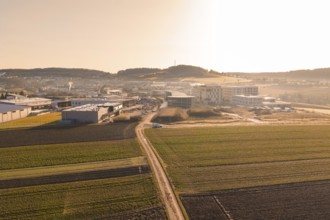 Extensive landscape with fields and buildings captured in low sunlight, new hospital at Calw Health