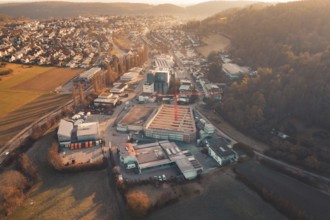 Extensive urban scene with construction crane and surrounding buildings in hilly landscape and