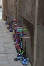 Parked children's scooters in front of a kindergarten, Venice, Veneto, Italy