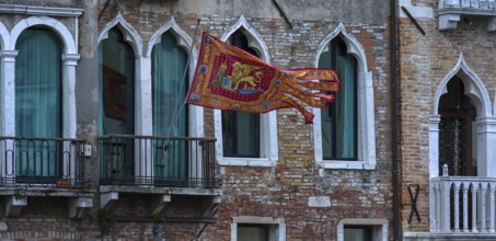 Waving flag of the Republic of Venice on a palace, Venice, Veneto, Italy