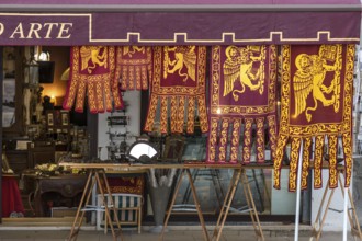 Flags of the Republic of Venice hang for sale in front of a shop, Venice, Veneto, Italy