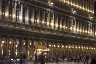Music band in the evening on St. Mark's Square under the arcades of the Procuraties, Venice,