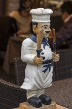 Cooking figure in front of a restaurant, Burano, Veneto, Italy